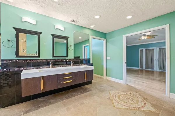 a spacious bathroom with a double vanity sink and a mirror