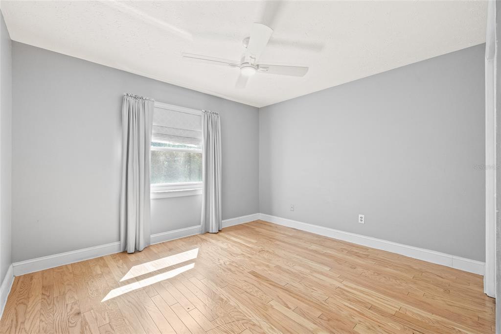 603 Cottage Grove Circle Valrico, FL 33594 - Photo 42 of 60 a view of a room with wooden floor and fan