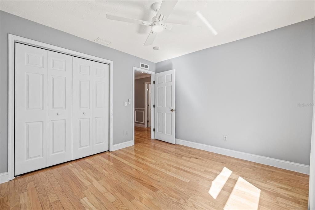 603 Cottage Grove Circle Valrico, FL 33594 - Photo 43 of 60 a view of empty room with wooden floor and fan
