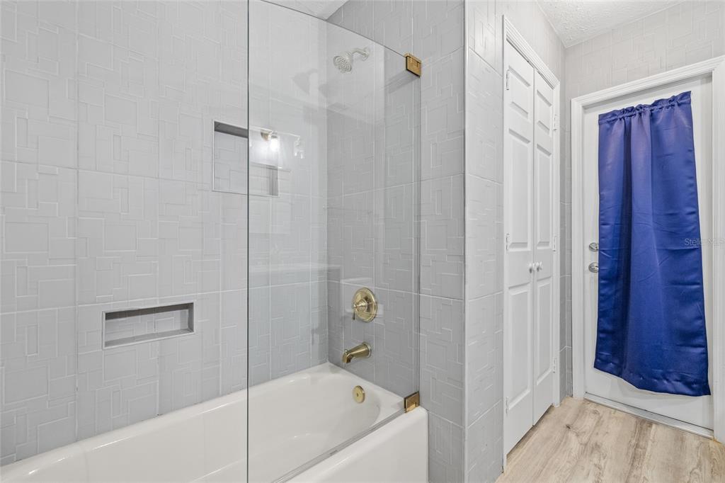 603 Cottage Grove Circle Valrico, FL 33594 - Photo 45 of 60 a bathroom with a bathtub and a shower