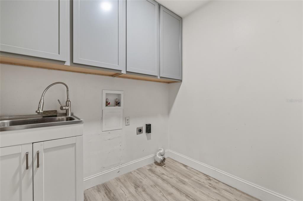 603 Cottage Grove Circle Valrico, FL 33594 - Photo 48 of 60 a view of a kitchen with white cabinets