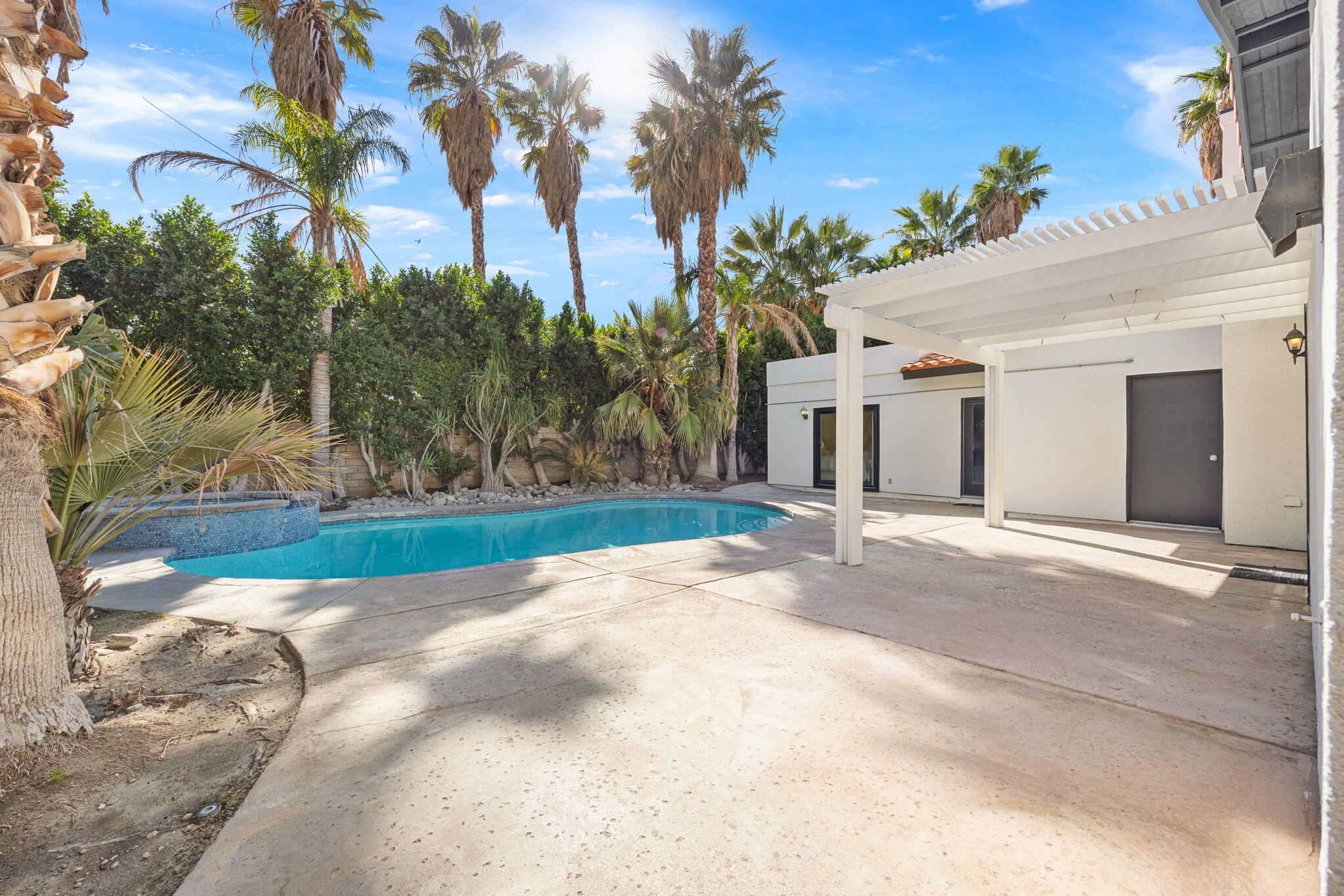 2900 North Cypress Road Palm Springs, CA 92262 - Photo 39 of 48 a view of a white house with a yard and palm trees