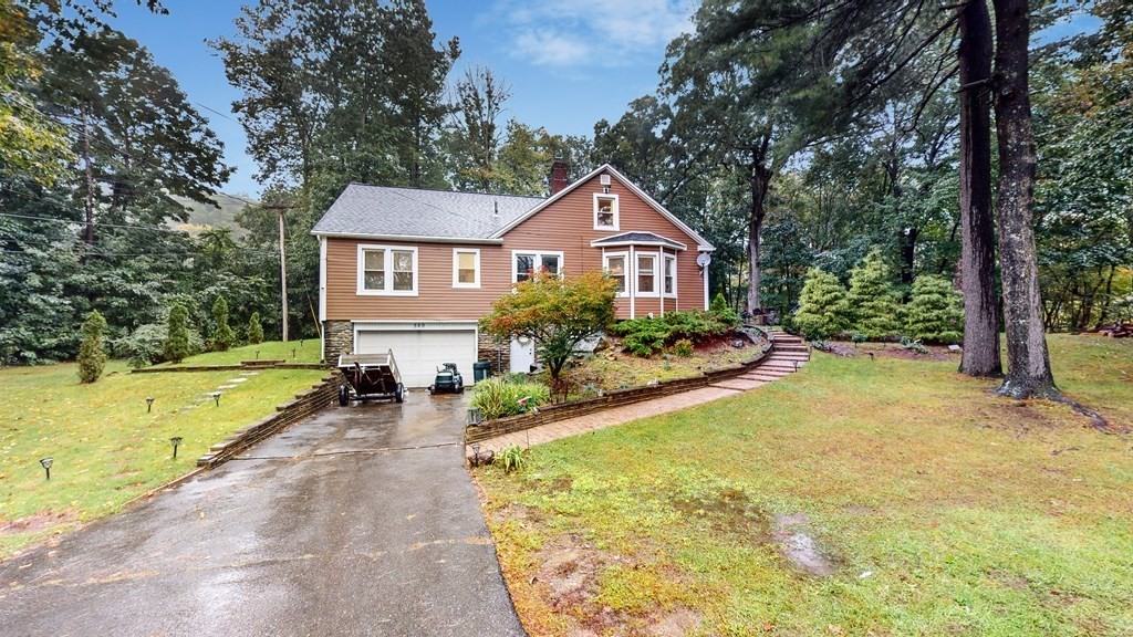 a view of a house with swimming pool and next to a yard