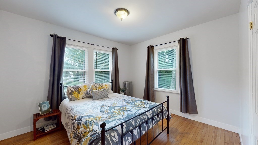 569 Mill Street Worcester, MA 01602 - Photo 11 of 24 a bedroom with a bed and a window