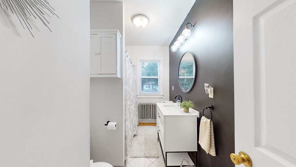 569 Mill Street Worcester, MA 01602 - Photo 12 of 24 a very nice looking room with a mirror and a table