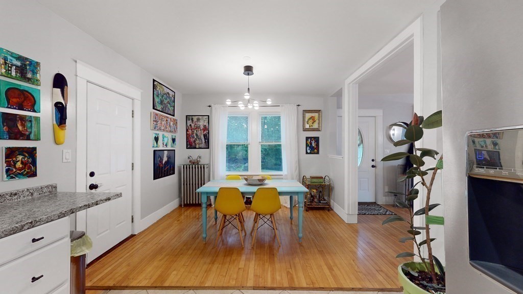 569 Mill Street Worcester, MA 01602 - Photo 3 of 24 a view of a dining room with furniture a rug and wooden floor