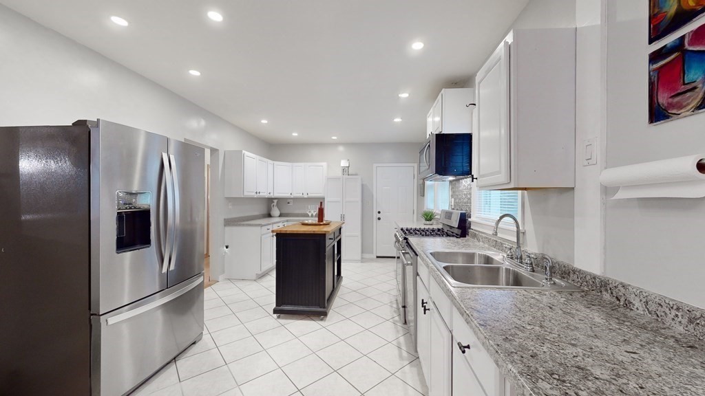 569 Mill Street Worcester, MA 01602 - Photo 5 of 24 a kitchen with stainless steel appliances granite countertop a refrigerator sink and stove