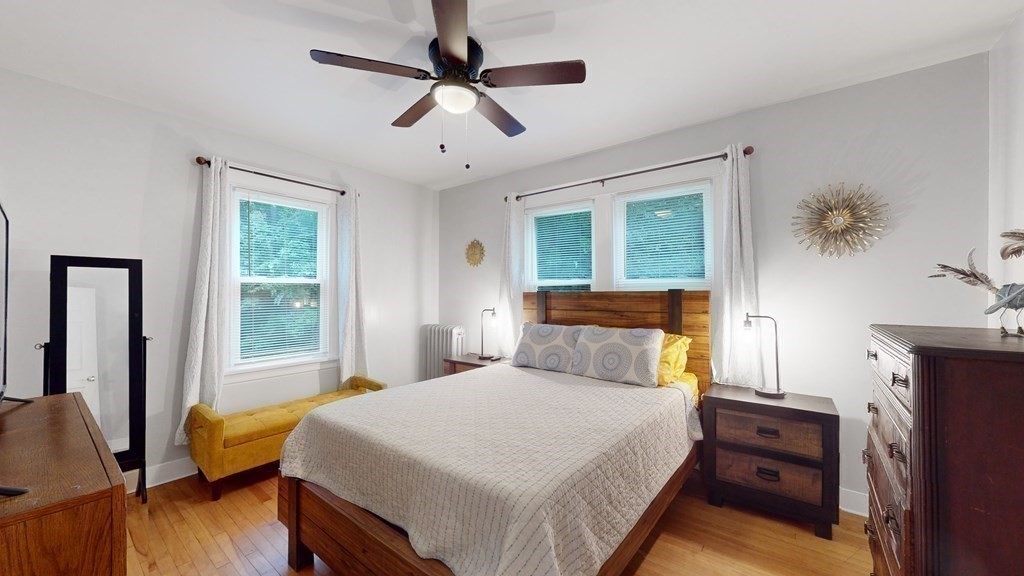 569 Mill Street Worcester, MA 01602 - Photo 7 of 24 a bedroom with a bed and wooden floor