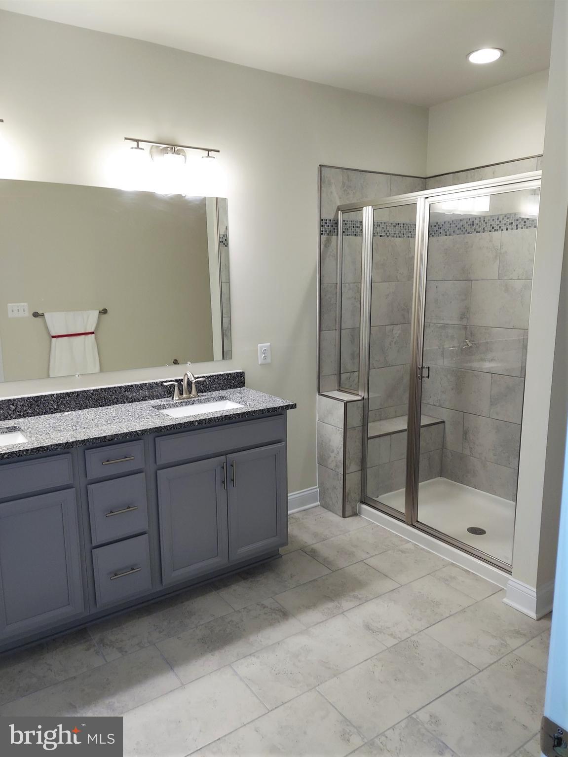 7140 Proclamation Place Frederick, MD 21703 - Photo 18 of 29 Upgraded tile and granite in bedroom #1's bathroom