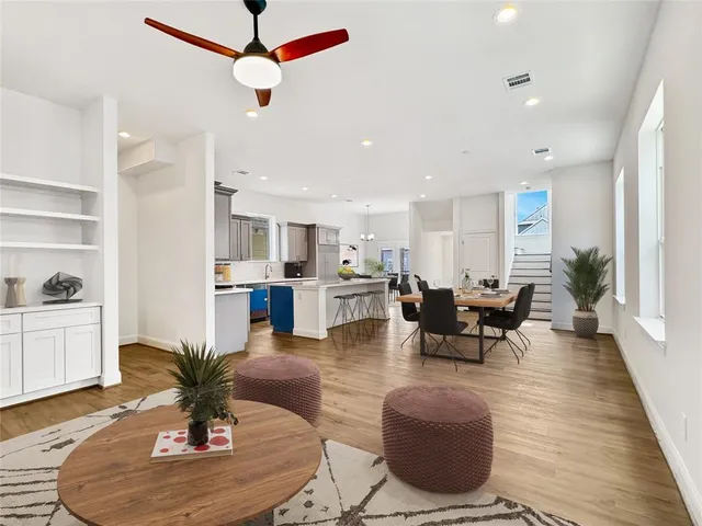 a living room with furniture kitchen view and a potted plant