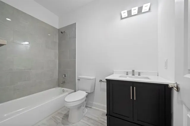 a bathroom with a toilet a sink and bathtub