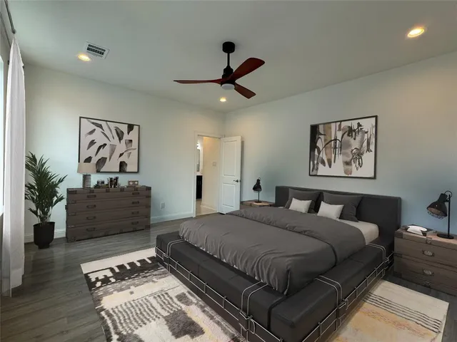 a bedroom with a large bed and a couch