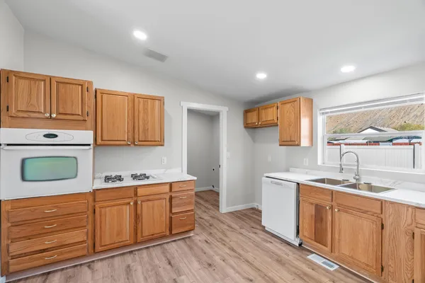 a kitchen with a sink window and cabinets