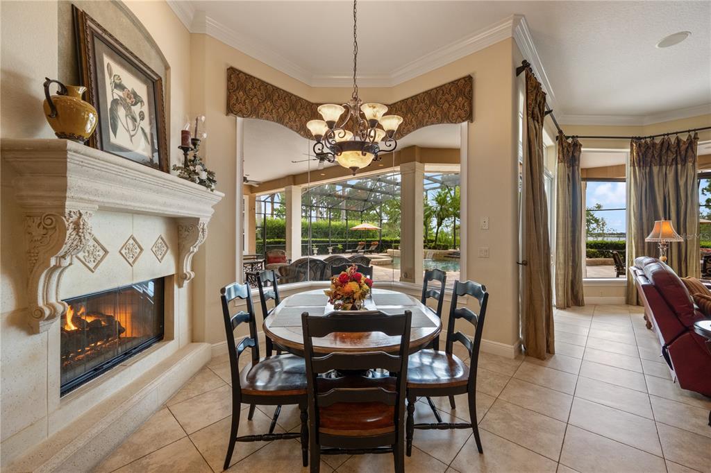 2016 Castelli Boulevard Mount Dora, FL 32757 - Photo 16 of 52 a dining room with furniture a fireplace and large windows