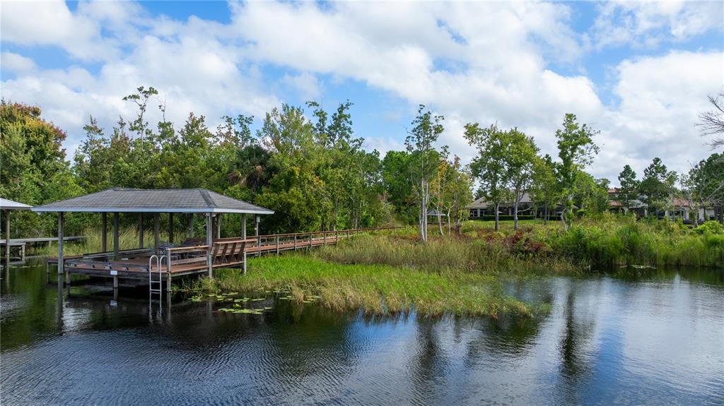 2016 Castelli Boulevard Mount Dora, FL 32757 - Photo 41 of 52 a view of a lake with a wooden deck and lake