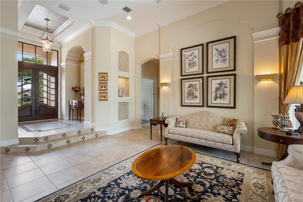 2016 Castelli Boulevard Mount Dora, FL 32757 - Photo 7 of 52 a living room with furniture a rug and wall painting