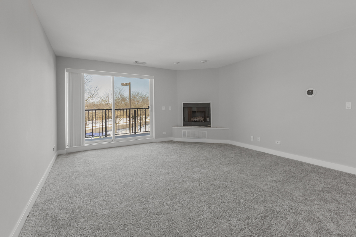 815 Leicester Road, Unit 211 Elk Grove Village, IL 60007 - Photo 5 of 19 a view of an empty room with a window
