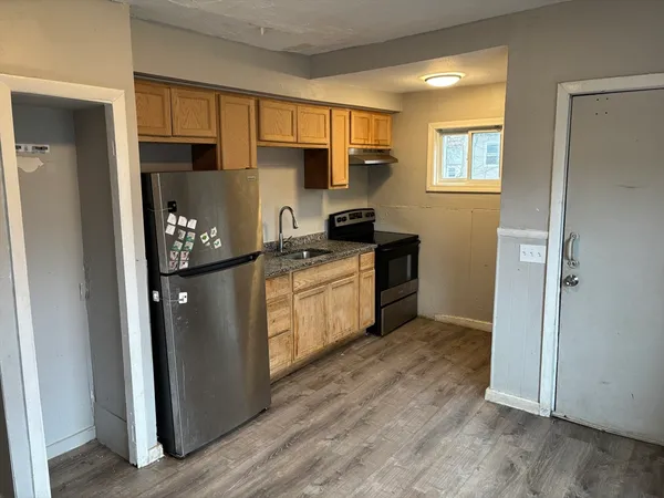 a kitchen with stainless steel appliances granite countertop a stove a refrigerator and a refrigerator