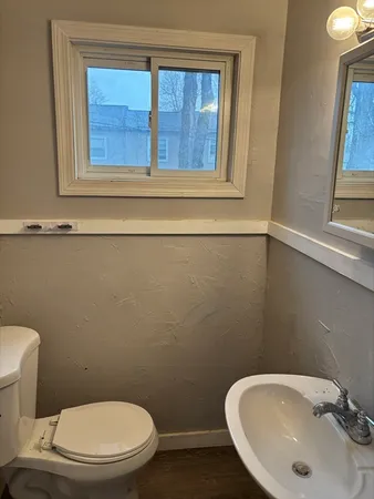 a white toilet sitting next to a bathroom sink