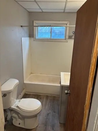 a bathroom with a toilet and a shower