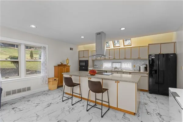 a kitchen with a sink cabinets and stainless steel appliances