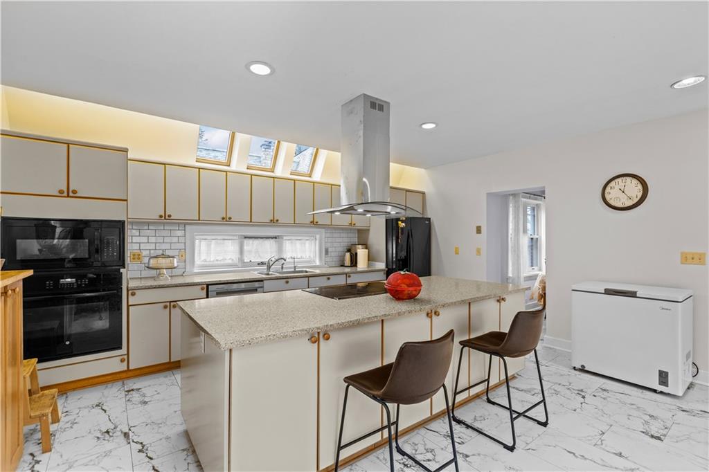 1355 Washington Road Pittsburgh, PA 15228 - Photo 18 of 49 Center island cooktop with a hood vent.