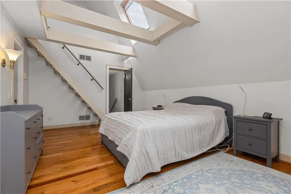 a bedroom with a bed and a couch