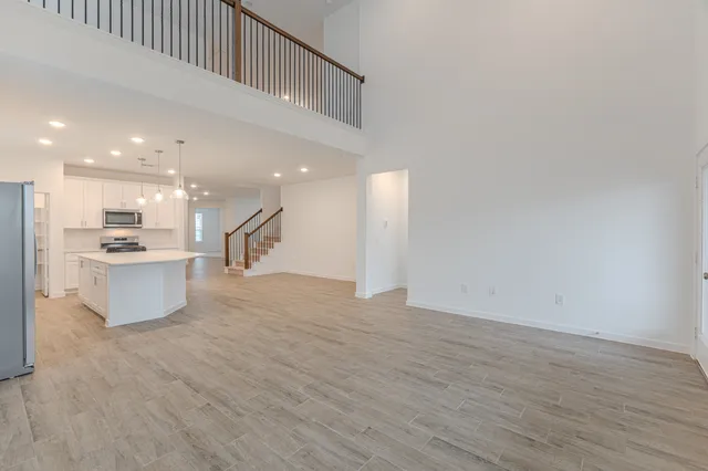 a view of kitchen with kitchen island wooden floor and center island