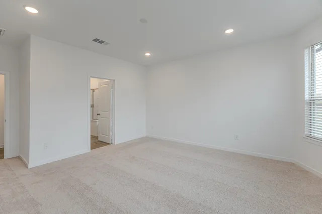 an empty room with windows and closet
