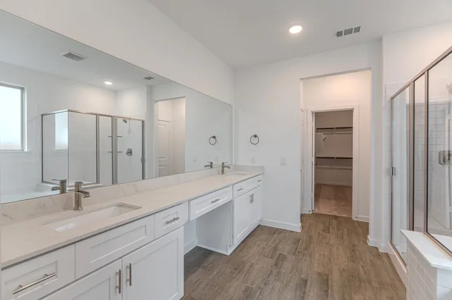 a spacious bathroom with a granite countertop sink a toilet and a large mirror