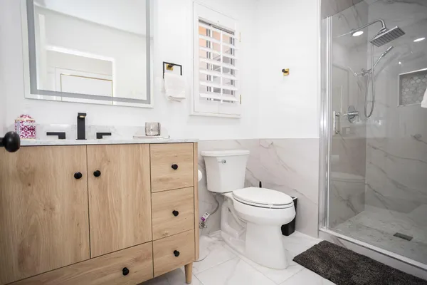a spacious bathroom with double vanity and a mirror
