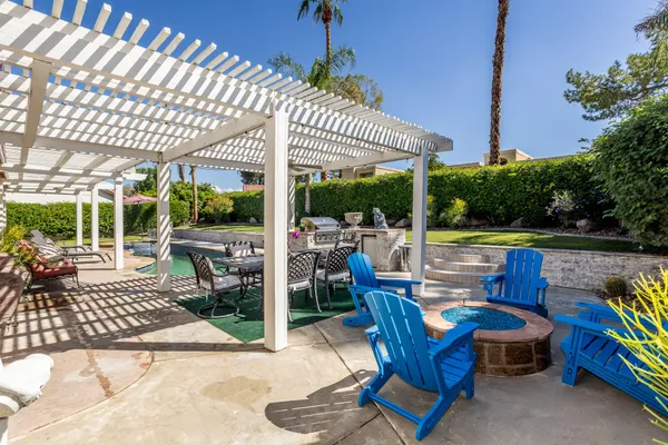 a view of swimming pool with a patio and a yard