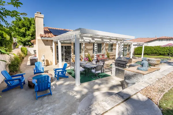 a view of a patio with couches table and chairs and potted plants
