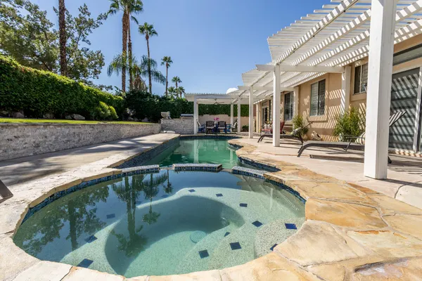 a large bedroom with a bed and window