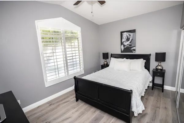 a kitchen with stainless steel appliances kitchen island granite countertop a sink and dishwasher with white cabinets