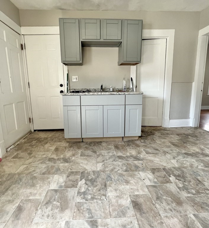 68-70 Suffolk Street Springfield, MA 01109 - Photo 11 of 19 a kitchen with granite countertop a sink a stove and a refrigerator