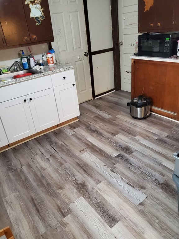 68-70 Suffolk Street Springfield, MA 01109 - Photo 17 of 19 a room with wooden floor and cabinets