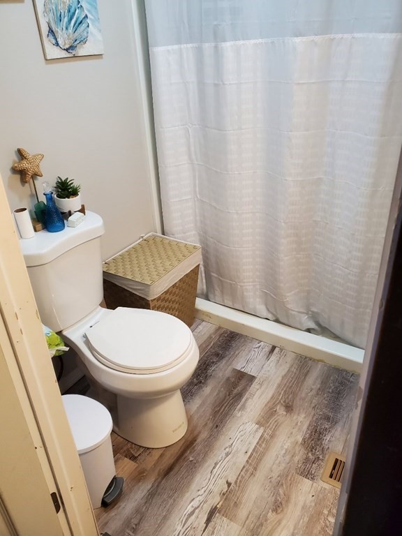 68-70 Suffolk Street Springfield, MA 01109 - Photo 18 of 19 a white toilet sitting next to a shower curtain