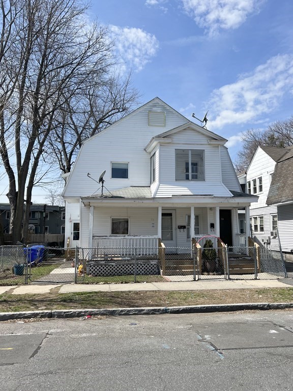 68-70 Suffolk Street Springfield, MA 01109 - Photo 2 of 19 a view of a white house with a large windows and a table and chairs
