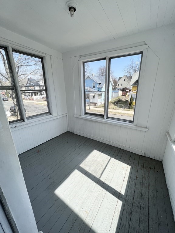 68-70 Suffolk Street Springfield, MA 01109 - Photo 3 of 19 a view of an empty room with wooden floor and a window