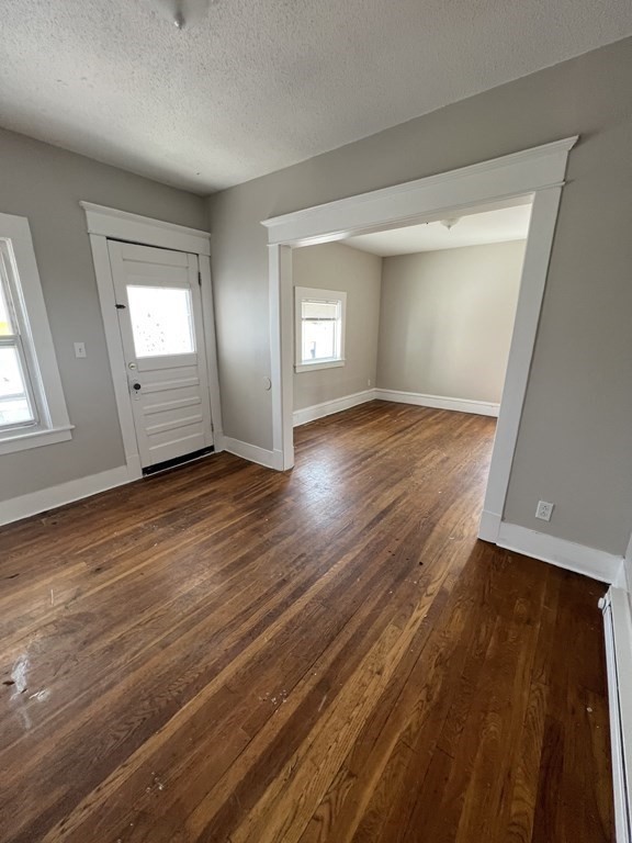 68-70 Suffolk Street Springfield, MA 01109 - Photo 4 of 19 an empty room with wooden floor and windows