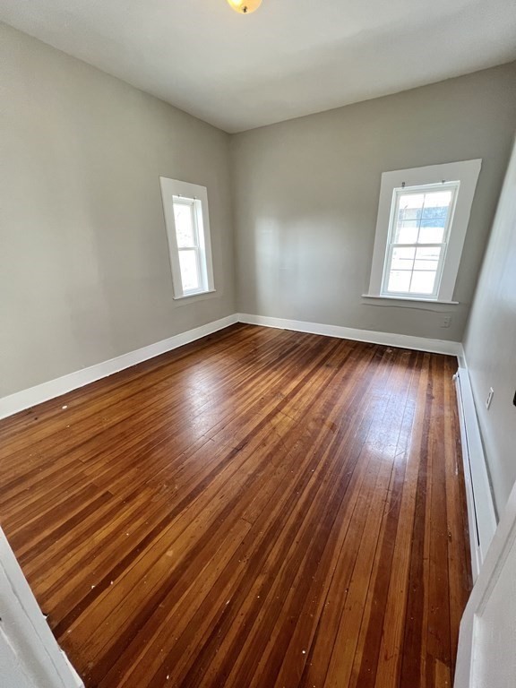 68-70 Suffolk Street Springfield, MA 01109 - Photo 7 of 19 a view of an empty room with wooden floor and a window