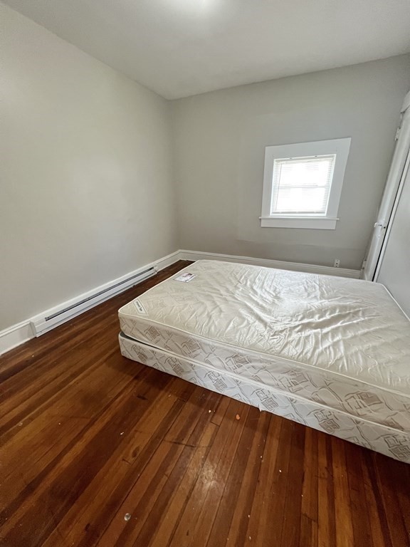 68-70 Suffolk Street Springfield, MA 01109 - Photo 8 of 19 a bedroom with a bed and window