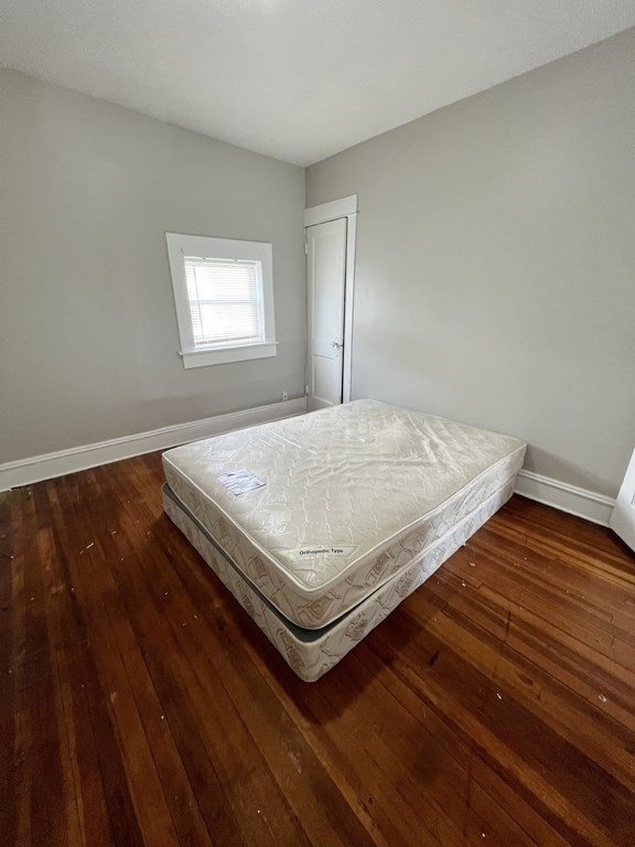 68-70 Suffolk Street Springfield, MA 01109 - Photo 9 of 19 a bedroom with wooden floor and window