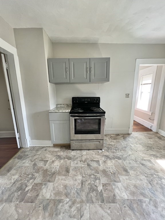 68-70 Suffolk Street Springfield, MA 01109 - Photo 10 of 19 a view of a kitchen with a stove cabinets and a window