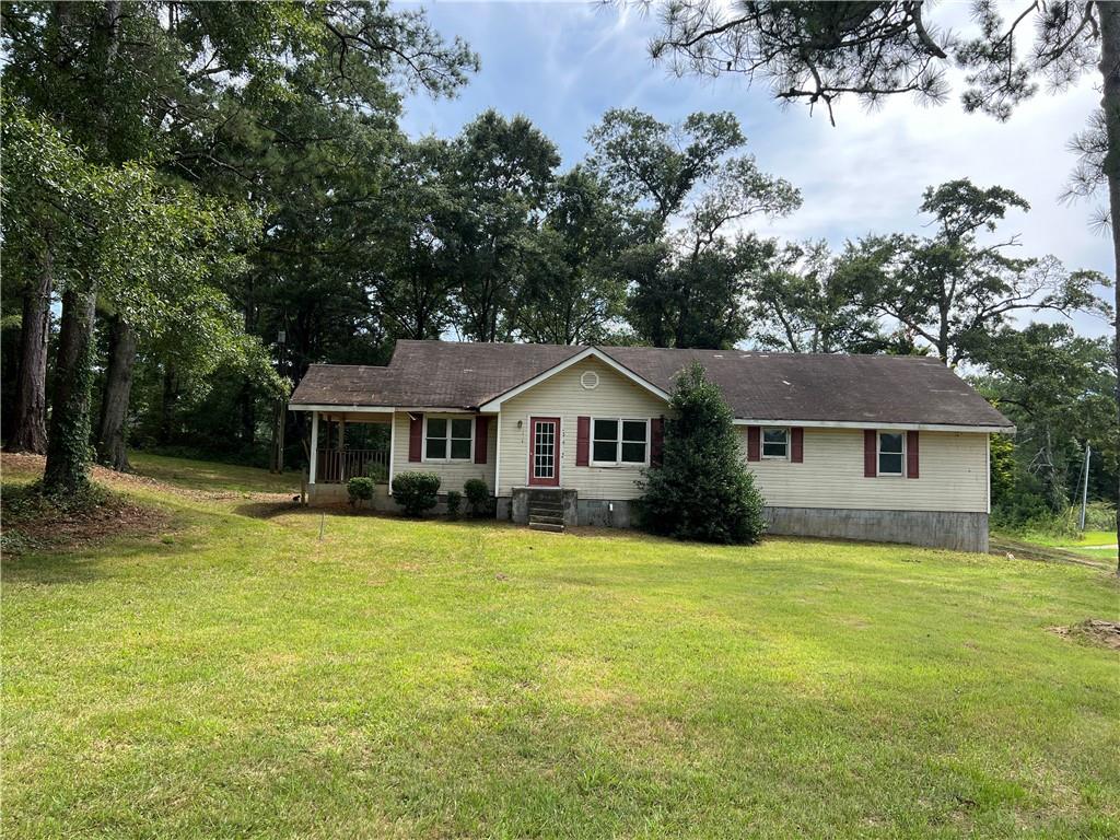 1018 Hampton Locust Grove Road Locust Grove, GA 30248 - Photo 1 of 1 a front view of a house with yard and trees