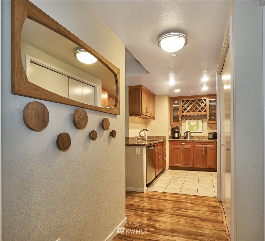 a large kitchen with stainless steel appliances granite countertop a refrigerator and a stove