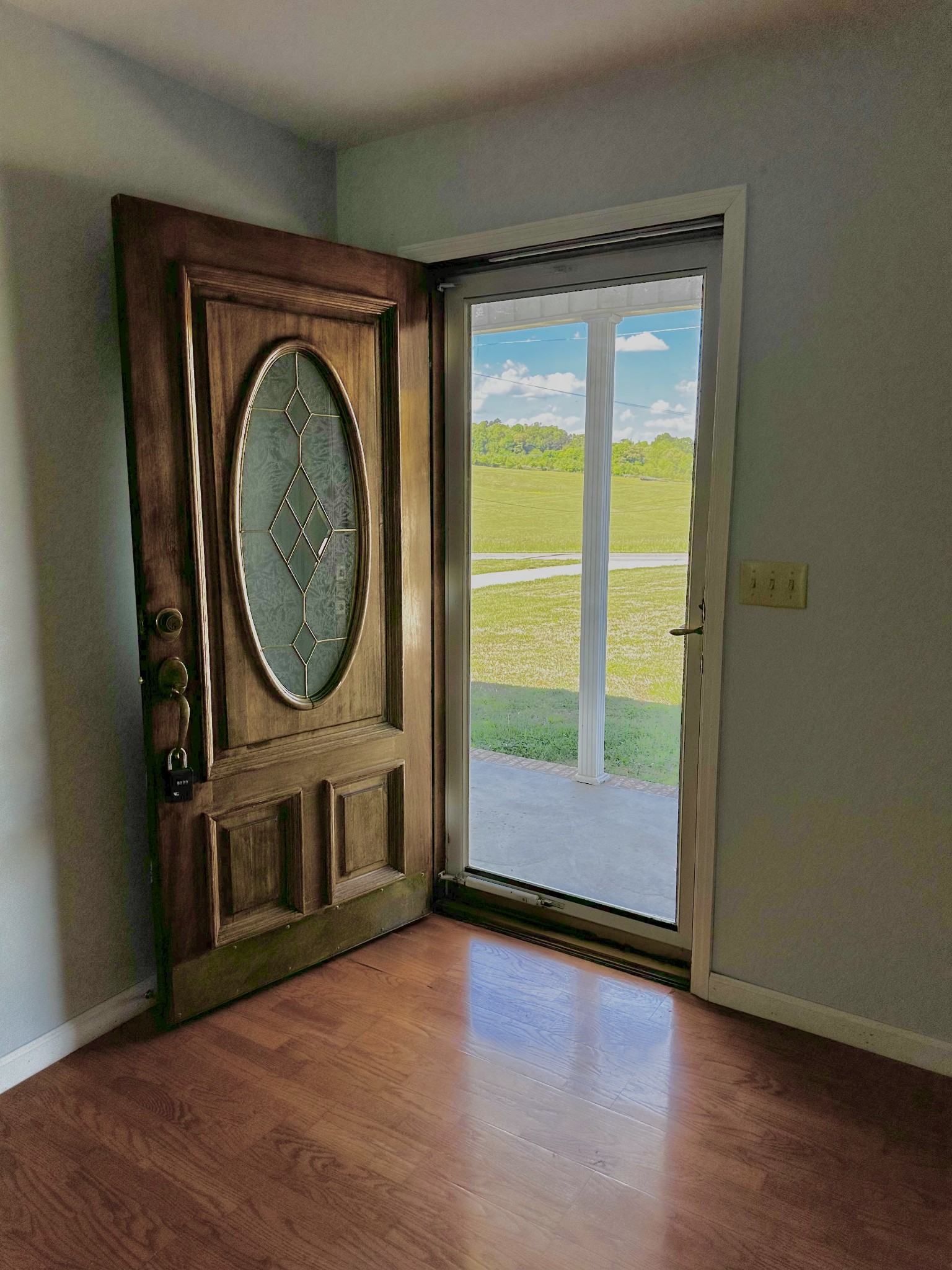 1691 Mullins Road Russellville, TN 37860 - Photo 2 of 23 an empty room with wooden floor mirror and windows