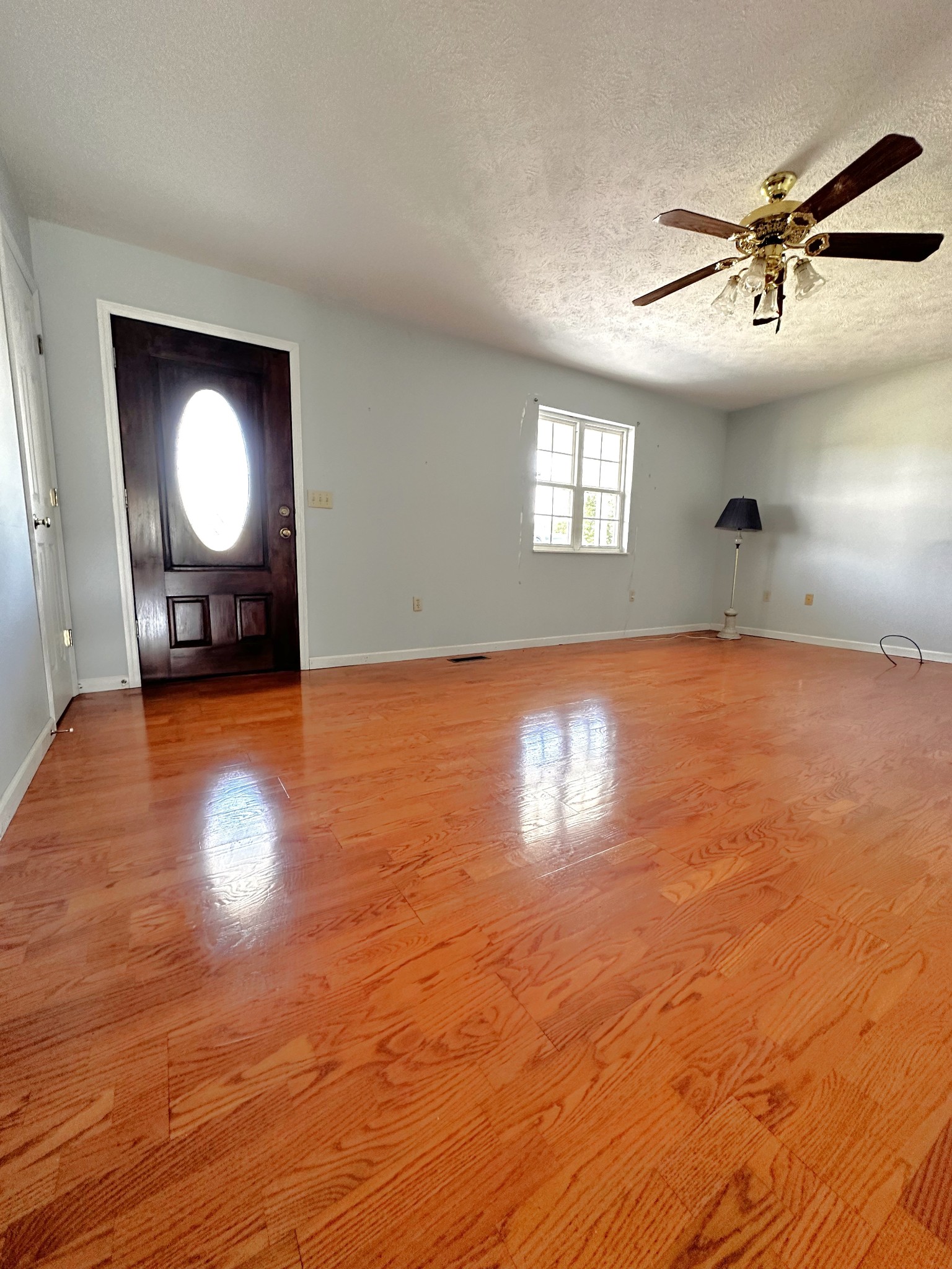 1691 Mullins Road Russellville, TN 37860 - Photo 3 of 23 a view of empty room with wooden floor and fan