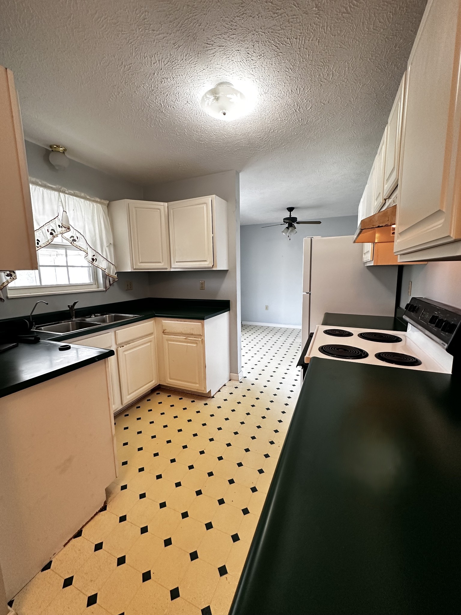 1691 Mullins Road Russellville, TN 37860 - Photo 7 of 23 a kitchen with granite countertop a sink a stove a refrigerator a window and cabinets